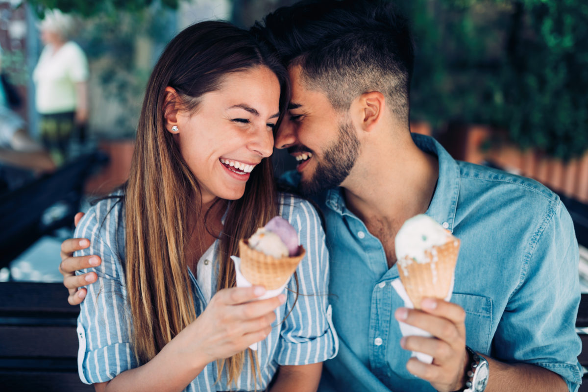 Couple eating ice cream outdoors