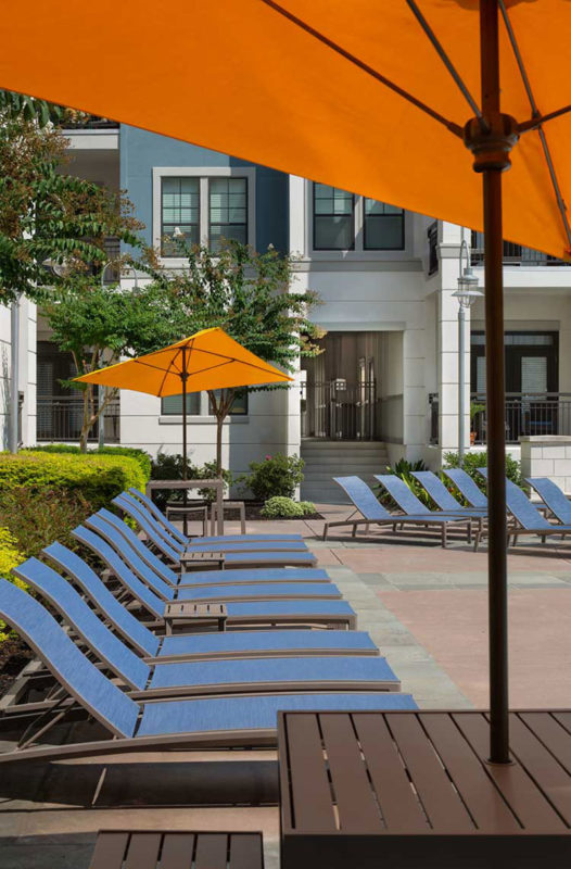 Lounge chairs with umbrellas by the pool