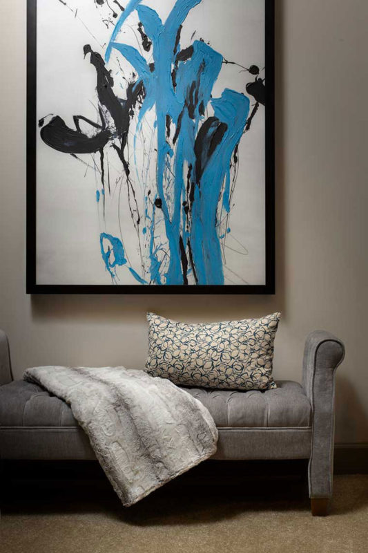 Lounge seat with abstract art on wall