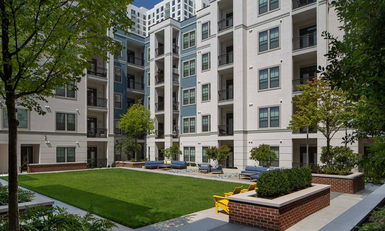 Small lawn area with seating amongst community buildings