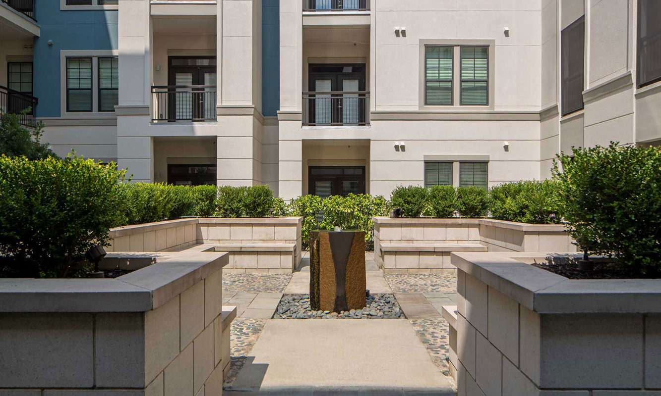Decorative fountain with stone bench seating around